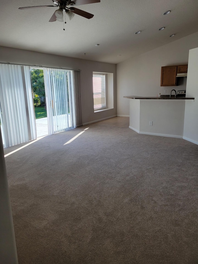 1701 SW Victor Ln SW, Port Saint Lucie, FL 34984 - unfurnished living room featuring light colored carpet and ceiling fan