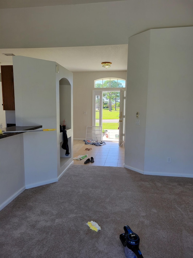 1701 SW Victor Ln SW, Port Saint Lucie, FL 34984 - carpeted entryway with baseboards and tile patterned floors