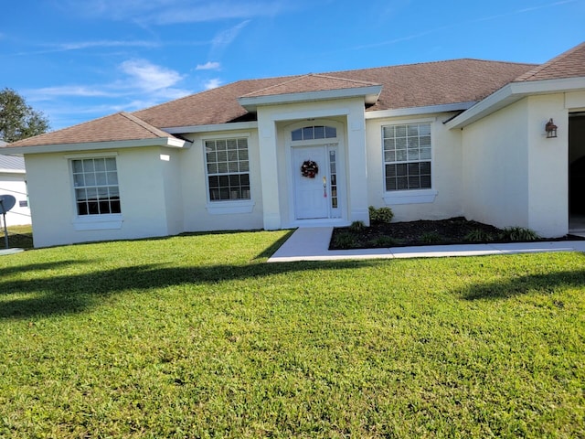 1701 SW Victor Ln SW, Port Saint Lucie, FL 34984 - single story home with a front yard, stucco siding, and a shingled roof