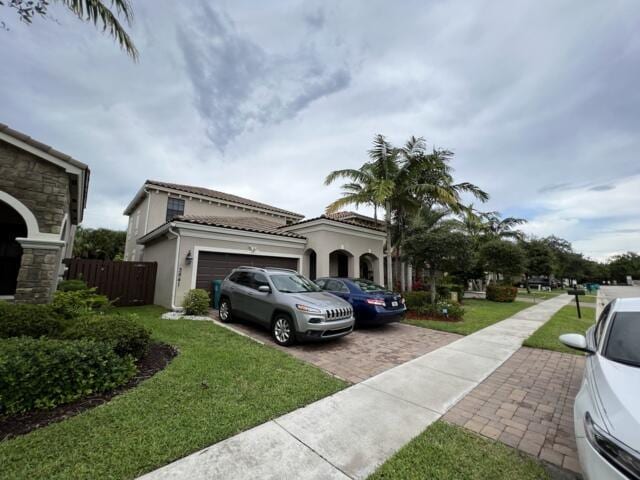 3841 E Aspen Leaf Dr, Boynton Beach, FL 33436 - view of front of property with decorative driveway, a garage, stucco siding, and a tiled roof
