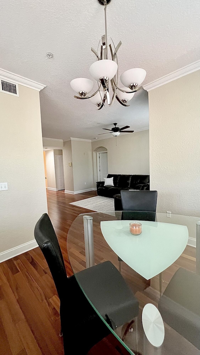 11021 Legacy Ln Unit 302, Palm Beach Gardens, FL 33410 - dining area with ornamental molding, ceiling fan, arched walkways, wood finished floors, and a textured ceiling