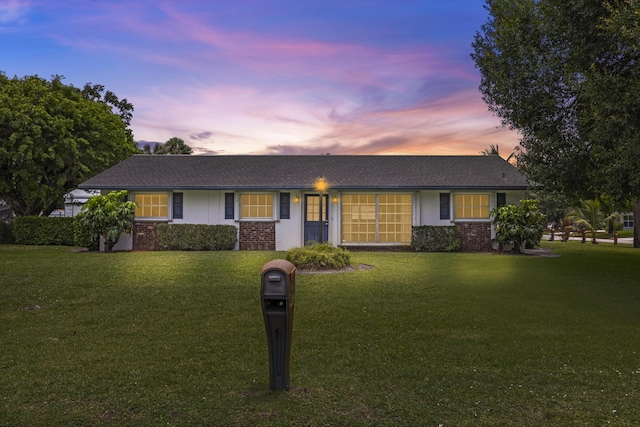 5557 S Shadyside Cir, West Palm Beach, FL 33415 - ranch-style home with a yard and brick siding