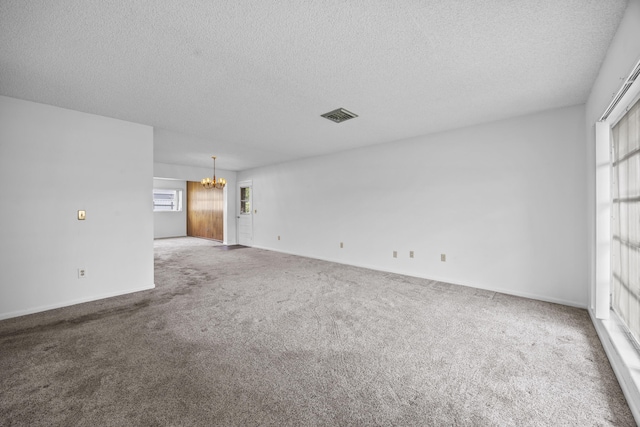 5557 S Shadyside Cir, West Palm Beach, FL 33415 - unfurnished living room with a chandelier, a textured ceiling, carpet floors, and baseboards