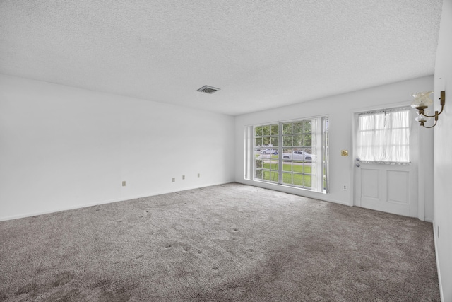 5557 S Shadyside Cir, West Palm Beach, FL 33415 - unfurnished living room featuring a textured ceiling and carpet flooring