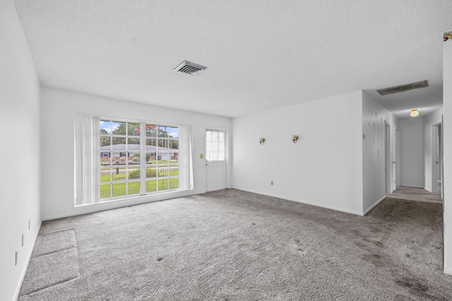 5557 S Shadyside Cir, West Palm Beach, FL 33415 - empty room featuring a textured ceiling, carpet flooring, and baseboards