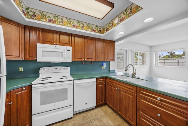 5557 S Shadyside Cir, West Palm Beach, FL 33415 - kitchen featuring white appliances, a sink, brown cabinets, light tile patterned flooring, and recessed lighting
