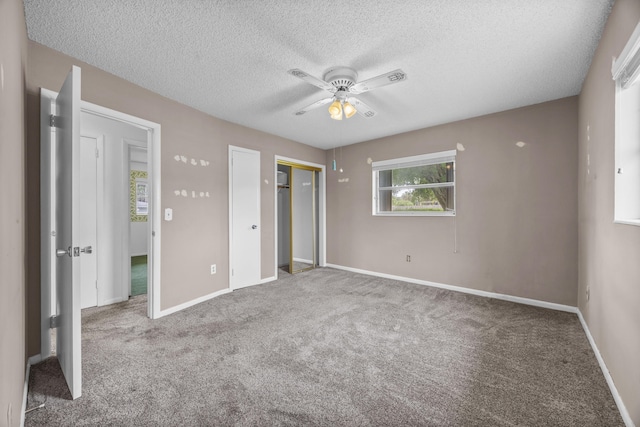 5557 S Shadyside Cir, West Palm Beach, FL 33415 - unfurnished bedroom with a textured ceiling, carpet flooring, baseboards, a closet, and a ceiling fan