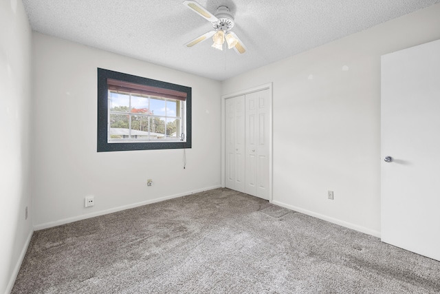 5557 S Shadyside Cir, West Palm Beach, FL 33415 - unfurnished bedroom featuring a textured ceiling, carpet, a closet, baseboards, and ceiling fan