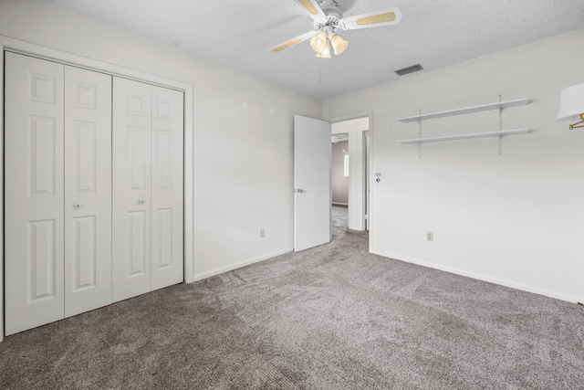 5557 S Shadyside Cir, West Palm Beach, FL 33415 - unfurnished bedroom featuring carpet flooring, a closet, baseboards, a textured ceiling, and ceiling fan