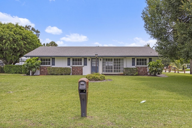 5557 S Shadyside Cir, West Palm Beach, FL 33415 - ranch-style home with brick siding and a front lawn