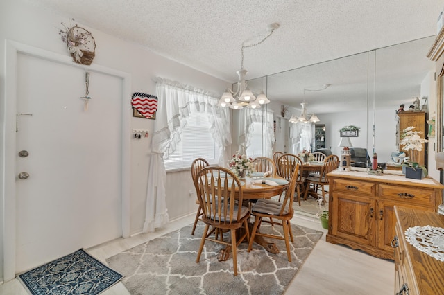 1225 NW 21st St Unit 7-710, Stuart, FL 34994 - dining space with a chandelier and a textured ceiling