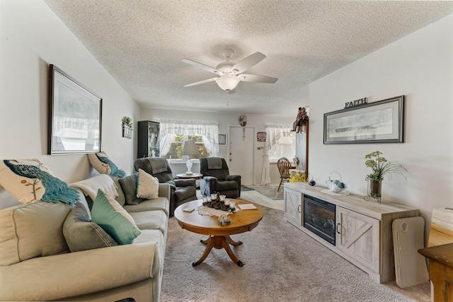 1225 NW 21st St Unit 7-710, Stuart, FL 34994 - living area featuring a textured ceiling, a ceiling fan, and light colored carpet