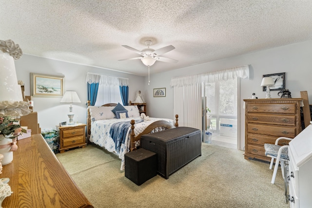 1225 NW 21st St Unit 7-710, Stuart, FL 34994 - bedroom with light colored carpet, a ceiling fan, and a textured ceiling