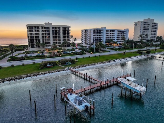 19850 Beach Rd Unit 8D, Jupiter, FL 33469 - dock area featuring a water view and a lawn