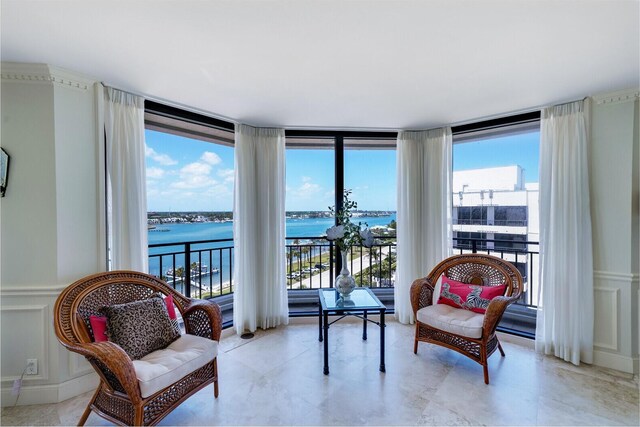 19850 Beach Rd Unit 8D, Jupiter, FL 33469 - living area with a water view, plenty of natural light, a decorative wall, and a wall of windows