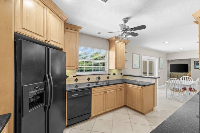 2070 NE 27th St, Lighthouse Point, FL 33064 - kitchen with black appliances, a peninsula, tasteful backsplash, light tile patterned floors, and ceiling fan