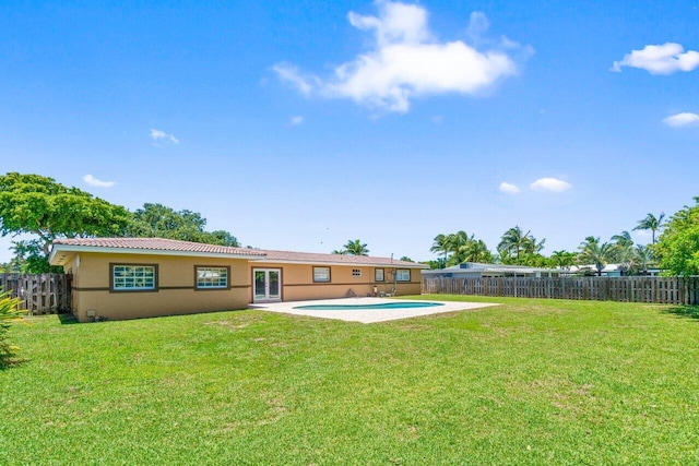2070 NE 27th St, Lighthouse Point, FL 33064 - rear view of house with stucco siding, french doors, a fenced backyard, and a tiled roof