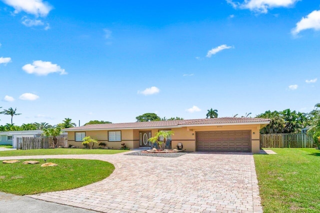 2070 NE 27th St, Lighthouse Point, FL 33064 - ranch-style home with decorative driveway, stucco siding, a garage, and a tile roof