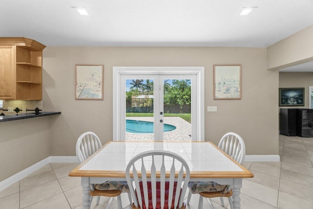 2070 NE 27th St, Lighthouse Point, FL 33064 - dining area with light tile patterned flooring and french doors