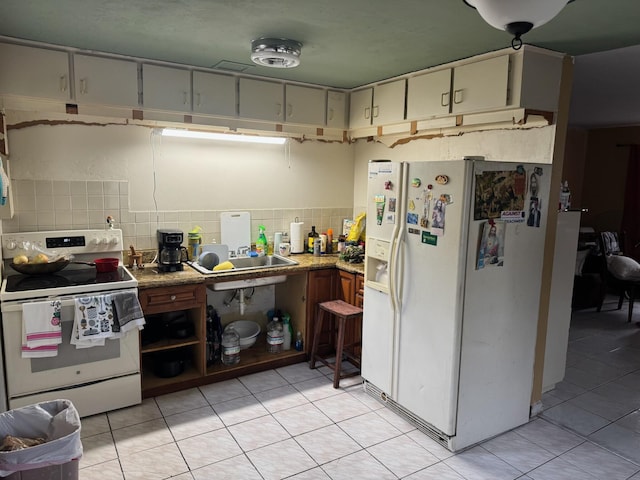 4601 Lake Ave, West Palm Beach, FL 33405 - kitchen featuring white appliances, light tile patterned floors, backsplash, and light countertops