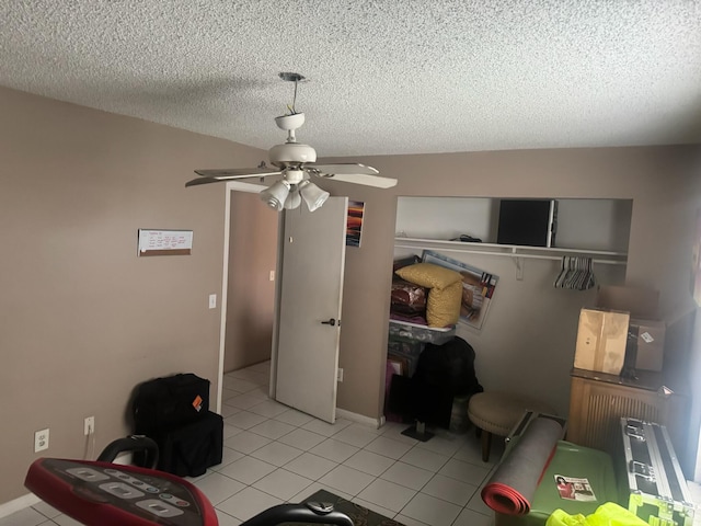 4601 Lake Ave, West Palm Beach, FL 33405 - bedroom featuring a textured ceiling, light tile patterned flooring, and a ceiling fan