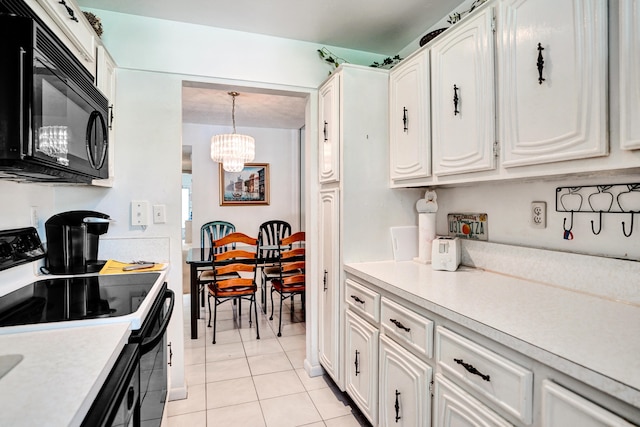 505 High Point Blvd N Unit A, Delray Beach, FL 33445 - kitchen featuring black microwave, electric range oven, light countertops, white cabinets, and light tile patterned flooring