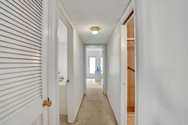 505 High Point Blvd N Unit A, Delray Beach, FL 33445 - corridor with a textured ceiling, light colored carpet, and baseboards