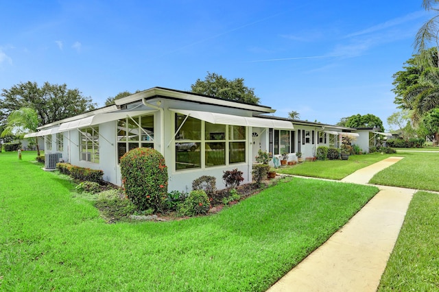 505 High Point Blvd N Unit A, Delray Beach, FL 33445 - mid-century home with central AC unit, a front lawn, and stucco siding