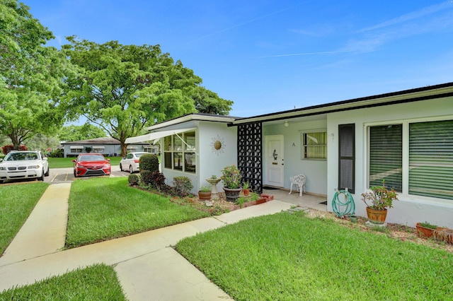 505 High Point Blvd N Unit A, Delray Beach, FL 33445 - view of front of home featuring stucco siding and a front lawn