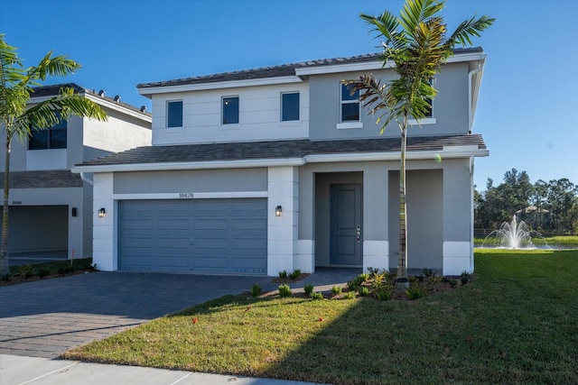 18478 Claybrook St, Jupiter, FL 33458 - traditional-style home with a garage, a front lawn, stucco siding, and decorative driveway