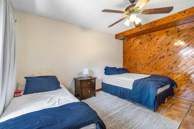 125 1st Ter, Palm Beach Gardens, FL 33418 - bedroom with wooden walls, an accent wall, and ceiling fan