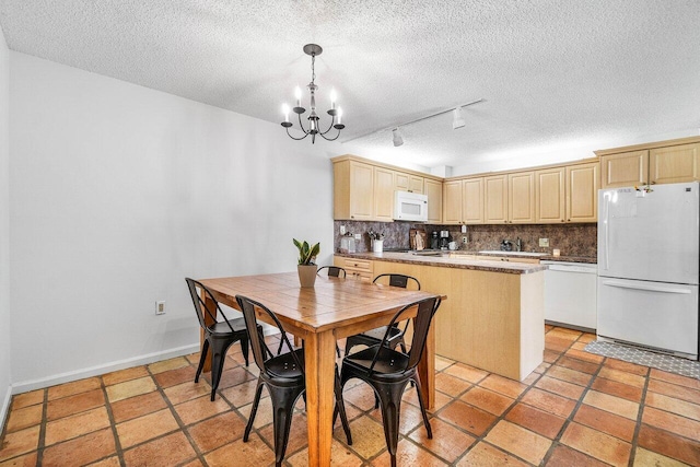 125 1st Ter, Palm Beach Gardens, FL 33418 - dining area with a textured ceiling, a chandelier, and rail lighting