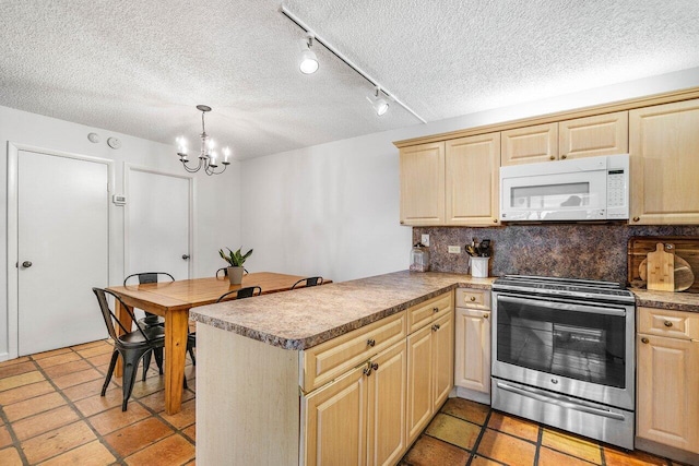 125 1st Ter, Palm Beach Gardens, FL 33418 - kitchen with white microwave, stainless steel electric range oven, light brown cabinetry, a textured ceiling, and a chandelier