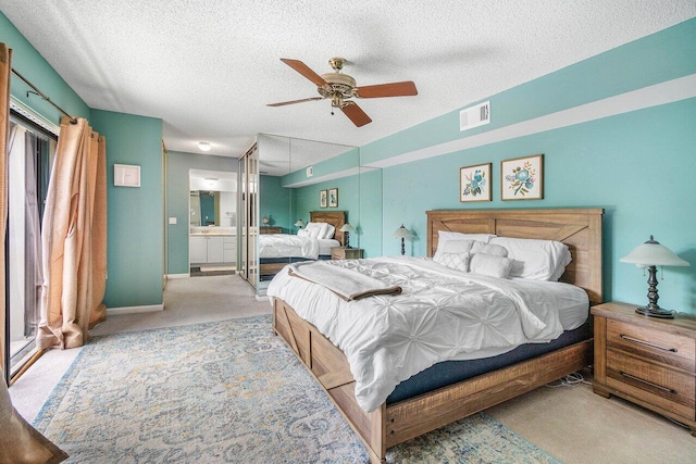 125 1st Ter, Palm Beach Gardens, FL 33418 - carpeted bedroom with a textured ceiling, ensuite bathroom, and ceiling fan