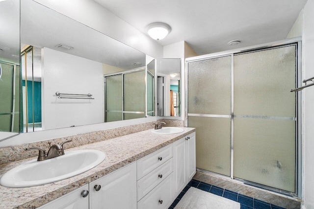 125 1st Ter, Palm Beach Gardens, FL 33418 - full bath with double vanity, a shower stall, and tile patterned flooring