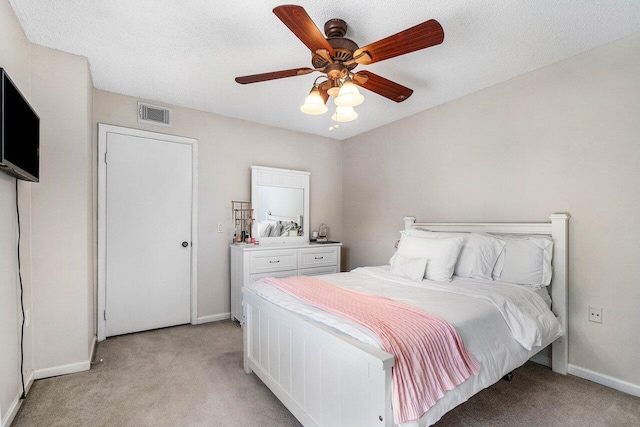 125 1st Ter, Palm Beach Gardens, FL 33418 - bedroom featuring light colored carpet, a ceiling fan, and a textured ceiling