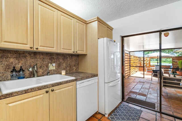 125 1st Ter, Palm Beach Gardens, FL 33418 - kitchen with white appliances, backsplash, light brown cabinets, and dark countertops