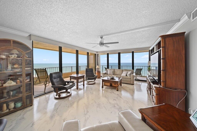 8750 S Ocean Dr Unit 731, Jensen Beach, FL 34957 - living room featuring ceiling fan, a textured ceiling, crown molding, floor to ceiling windows, and marble finish flooring