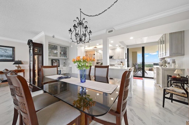8750 S Ocean Dr Unit 731, Jensen Beach, FL 34957 - dining space featuring a chandelier, light marble finish flooring, a textured ceiling, crown molding, and recessed lighting