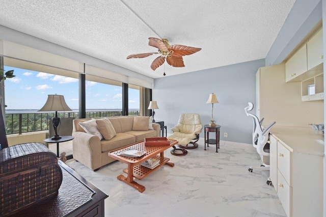 8750 S Ocean Dr Unit 731, Jensen Beach, FL 34957 - living area featuring plenty of natural light, ceiling fan, a textured ceiling, and light marble finish floors