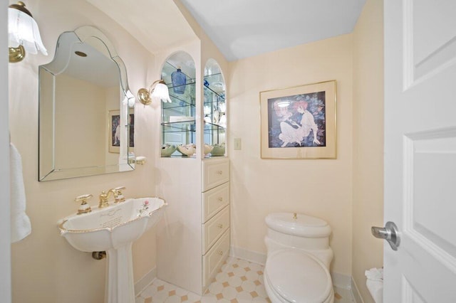 8750 S Ocean Dr Unit 731, Jensen Beach, FL 34957 - half bath featuring baseboards, toilet, and tile patterned floors