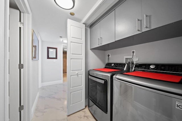 8750 S Ocean Dr Unit 731, Jensen Beach, FL 34957 - laundry area with cabinet space, light marble finish flooring, washer and dryer, and baseboards