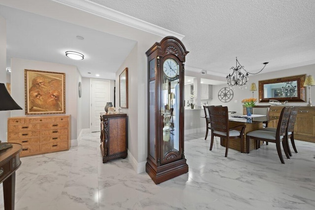 8750 S Ocean Dr Unit 731, Jensen Beach, FL 34957 - dining room featuring a textured ceiling, light marble finish floors, ornamental molding, a chandelier, and baseboards