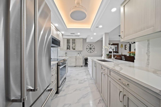 8750 S Ocean Dr Unit 731, Jensen Beach, FL 34957 - kitchen with stainless steel appliances, a sink, a raised ceiling, recessed lighting, and light marble finish floors