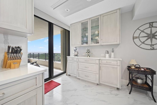 8750 S Ocean Dr Unit 731, Jensen Beach, FL 34957 - kitchen with light marble finish flooring, light countertops, and glass insert cabinets