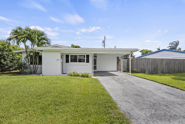 407 Riverside Dr, Palm Beach Gardens, FL 33410 - view of front of house with asphalt driveway, an attached carport, and brick siding