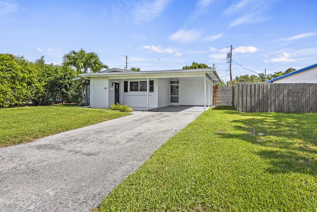 407 Riverside Dr, Palm Beach Gardens, FL 33410 - ranch-style home featuring asphalt driveway and a carport