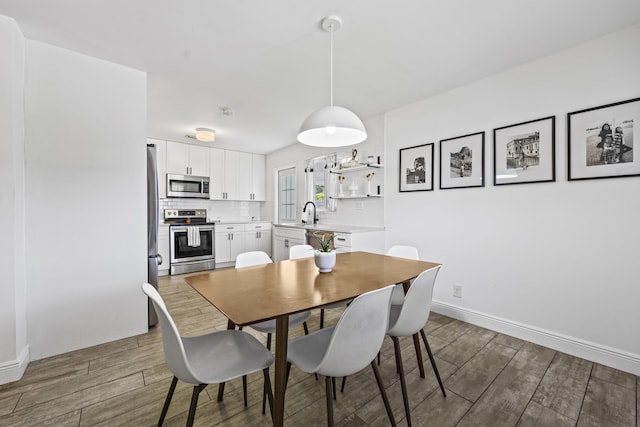 407 Riverside Dr, Palm Beach Gardens, FL 33410 - dining area featuring wood finished floors and baseboards