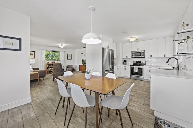 407 Riverside Dr, Palm Beach Gardens, FL 33410 - dining space featuring light wood finished floors and baseboards