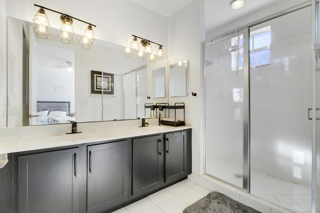 500 Pacific Grove 3 Dr Unit 3, West Palm Beach, FL 33401 - ensuite bathroom featuring double vanity, a shower stall, tile patterned floors, and a ceiling fan